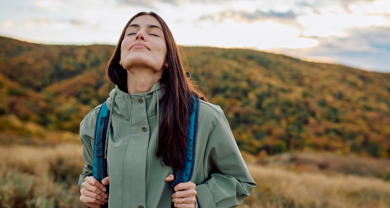 Happy woman hiking practising mindfulness